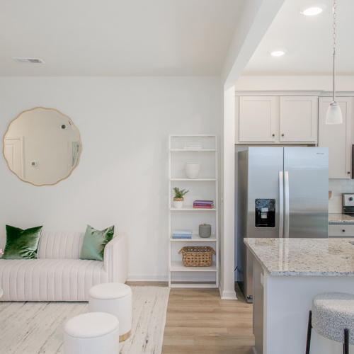 Luxury kitchen with an island and seating at Harmon Foxbank townhomes in Moncks Corner